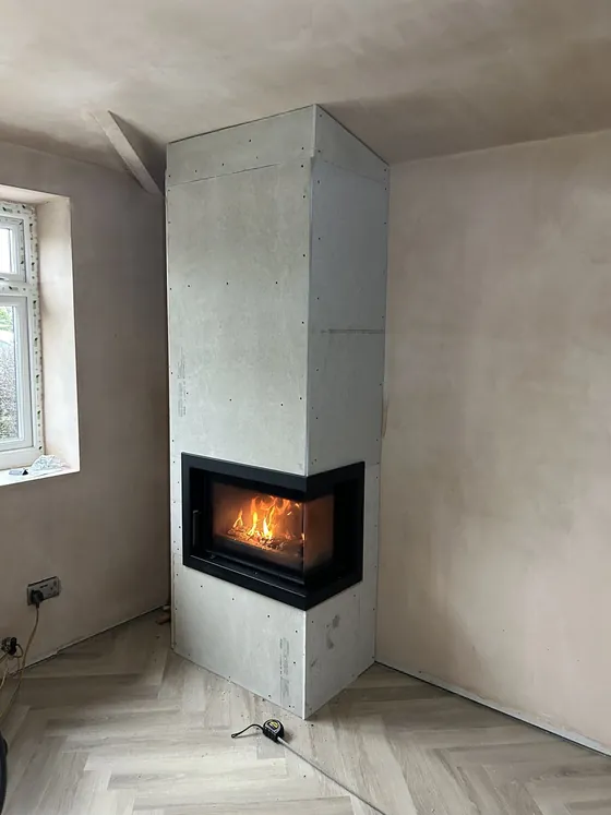Contemporary inset stove set into a smooth polished plaster chimney breast