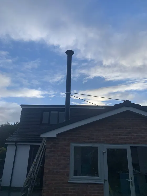 Flue terminal and cowl fitted above the roofline